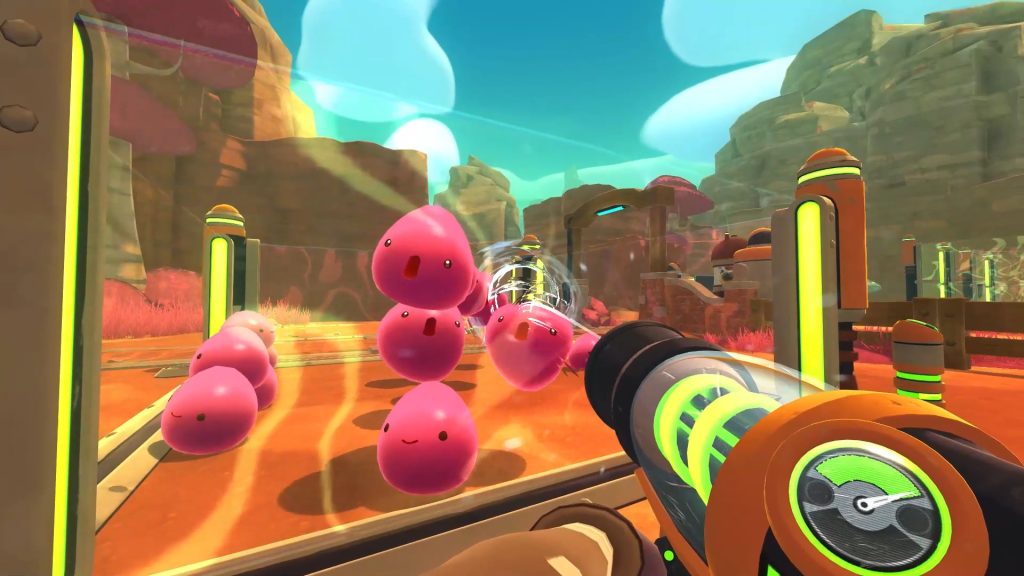 Pink slimes beside ranch equipment in Slime Rancher.