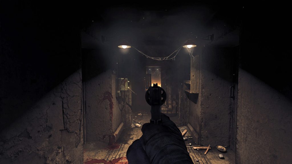 A weapon aimed down a dark bunker corridor in Amnesia: The Bunker.