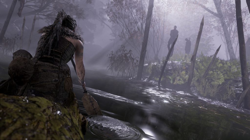 Senua moving through a misty wooded wetland in Hellblade: Senua's Sacrifice.