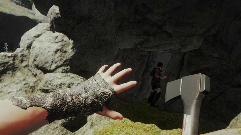 A first-person view of an axe and a rocky forest landscape in The Forest.