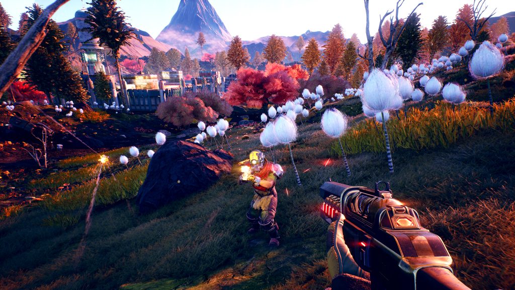 A first-person view across a colourful alien landscape in The Outer Worlds.